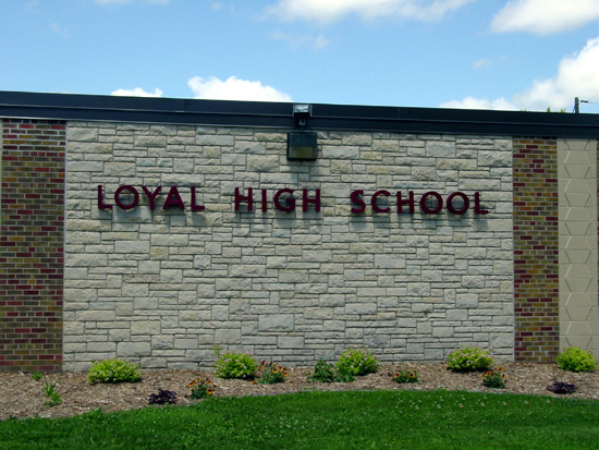 Closeup of the Loyal High School sign on the side of the building